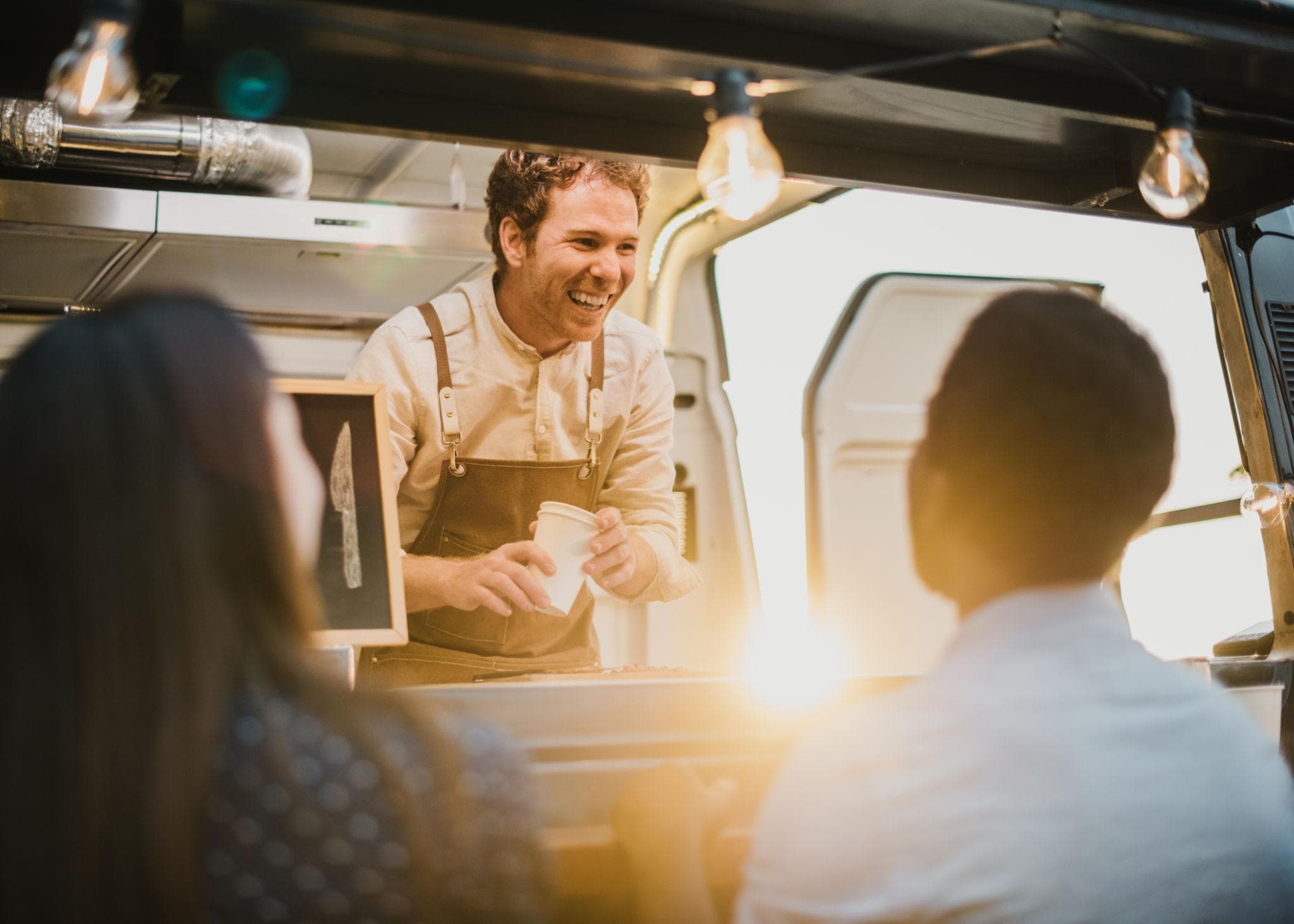 Food truck operator serving customers